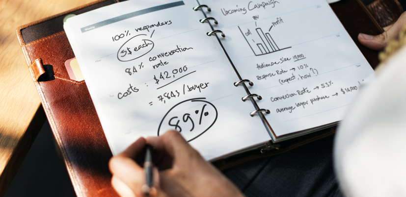 Woman writing and planning business strategy